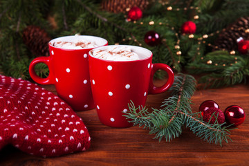 Red mugs with hot chocolate and marshmallows