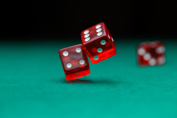 Photo of dice falling on green table