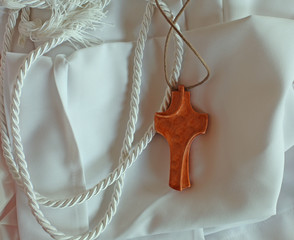 white tunic with wooden cross