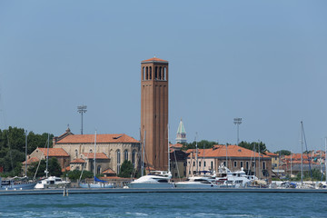 bell tower of Saint  Elena Island in Venice in Italy and th boat