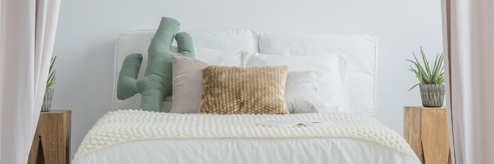 White bed in bright bedroom