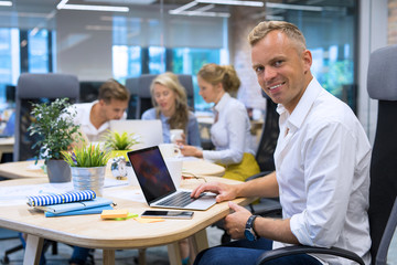 Man using laptop in conference room