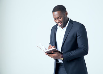 African American business man making a note in his notebook