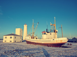 Fototapeta premium Old fisherman boat in Iceland in grunge colored design