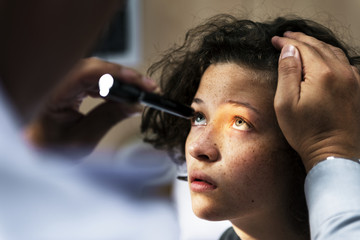 Young Caucasian girl getting an eye examination - obrazy, fototapety, plakaty