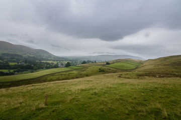 Green farmland on the hills above Sedbergh town, England