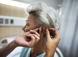 Asian old woman having her ears checked