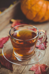 Cup of tea on the rustic background with autumn decoration. Selective focus. Shallow depth of field.
