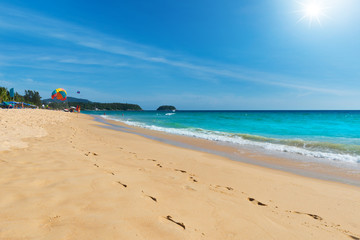 Beach footprints. A long track  footprints at tropical sand beach in clear sunny day with sunbeam blue sky.