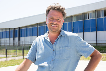 A man smiling in the sun outside outdoors