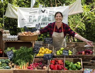 Greengrocer selling organic fresh agricultural product at farmer market