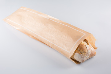 A french baguette in kraft paper packaging