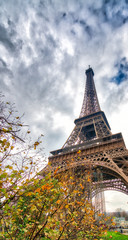 Fototapeta na wymiar Skyward view of Eiffel Tower on a cloudy winter day - France