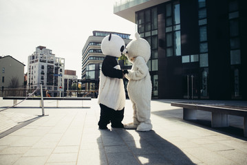 Panda and teddy bear having fun around the city