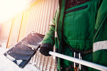 Shovel. Close-up of a shovel for snow cleaning in winter in the hands of a man.