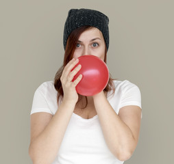 Woman Blowing Balloon Playful Studio Portrait