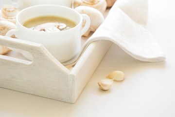 Two bowl with traditilnal mushroom soup cream on white table cloth