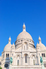 Obraz premium Sacré Coeur cathedral white facade front with deep blue sky above, Paris, France