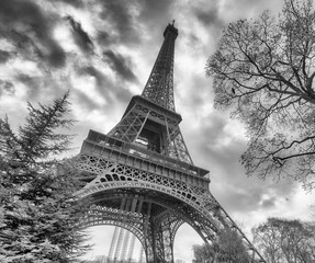 Skyward view of Eiffel Tower on a cloudy winter day - France