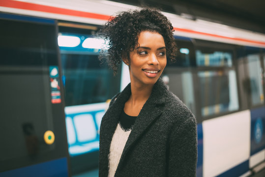 Happy Young Black Woman Inside The Underground Station Waiting For The Train