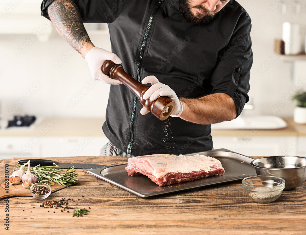 Sticker Man cooking meat steak on kitchen