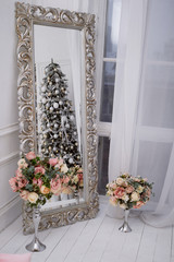 Christmas tree decorated with white balls and frost