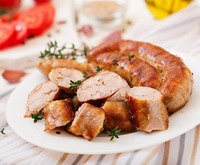 Baked homemade sausage on a white plate. Thanksgiving Day.