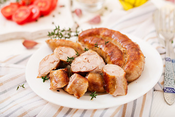 Baked homemade sausage on a white plate. Thanksgiving Day.