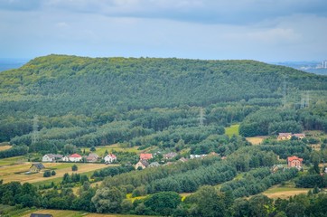 Summer rural landscape. Homes in the countryside among the green hills.