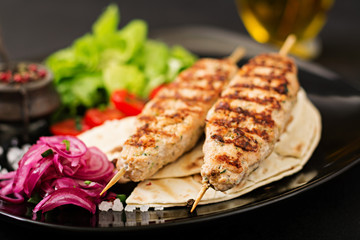 Minced Lula kebab grilled turkey (chicken) with fresh vegetables.