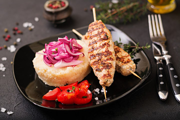 Minced Lula kebab grilled turkey (chicken) with fresh tomato and bulgur