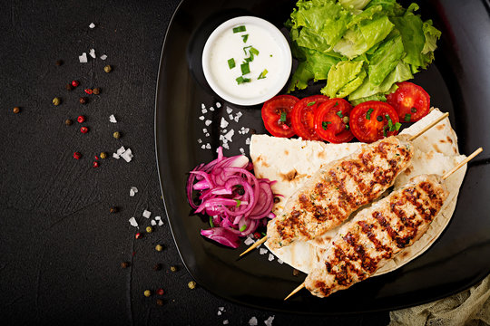 Minced Lula kebab grilled turkey (chicken) with fresh vegetables. Top view