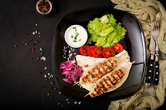 Minced Lula kebab grilled turkey (chicken) with fresh vegetables. Top view