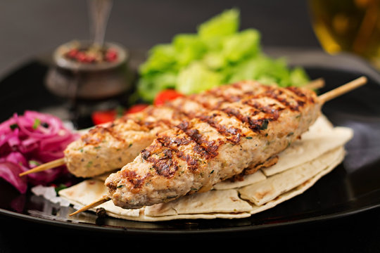 Minced Lula kebab grilled turkey (chicken) with fresh vegetables.