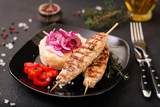 Minced Lula kebab grilled turkey (chicken) with fresh tomato and bulgur