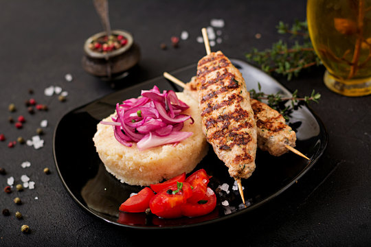 Minced Lula kebab grilled turkey (chicken) with fresh tomato and bulgur