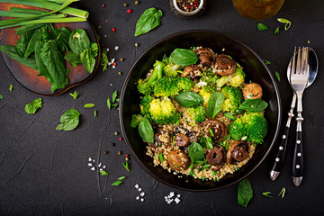 Dietary menu. Healthy vegan salad of vegetables - broccoli, mushrooms, spinach and quinoa in a bowl. Flat lay. Top view