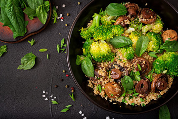 Dietary menu. Healthy vegan salad of vegetables - broccoli, mushrooms, spinach and quinoa in a bowl. Flat lay. Top view