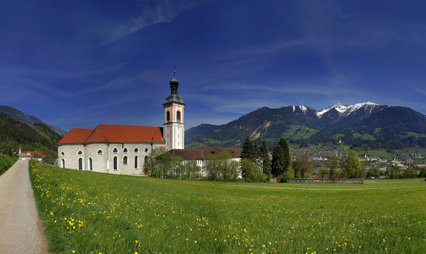 Abbey St. Georgenberg, Austria. View to abbey and church with alps in the background.