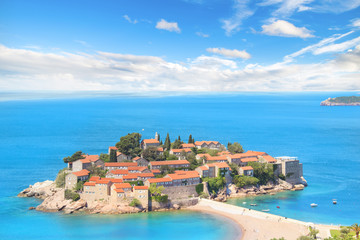 Fototapeta na wymiar Beautiful view of the island-resort of St. Stefan (Sveti Stefan) on the Budva Riviera, Budva, Montenegro on a sunny day