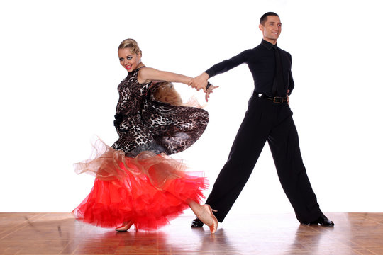 Latino dancers in ballroom against white background