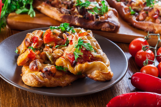 Sliced traditional Turkish pide with meat and vegetables