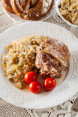 Pork knuckle with fried sauerkraut and tomatoes