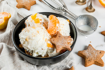 Winter Ice cream with gingerbread and tangerines, on white marble background, copy space