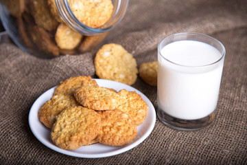Glass of milk and cookies made of nuts.