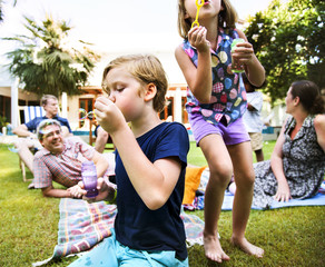 Kids enjoying blowing bubble outdoors