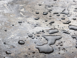 Large drops of water on black grunge background