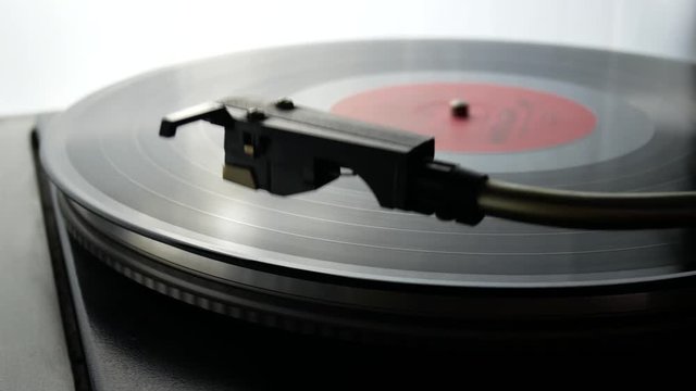 Spinning Record Player With Vintage Vinyl. Turntable Player And Vinyl Record With Dropping Stylus Needle Running Old CD And Playing Music on White Background