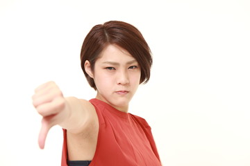 young Japanese woman with thumbs down gesture