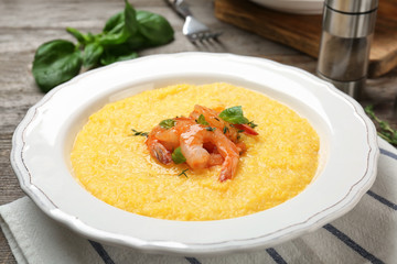 Plate with fresh tasty shrimp and grits on table, closeup